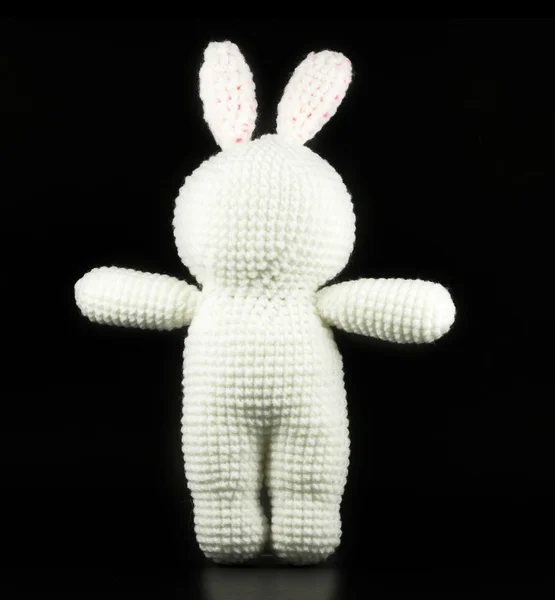 Poupée de lapin blanc au crochet à la main sur fond noir, face arrière — Photo