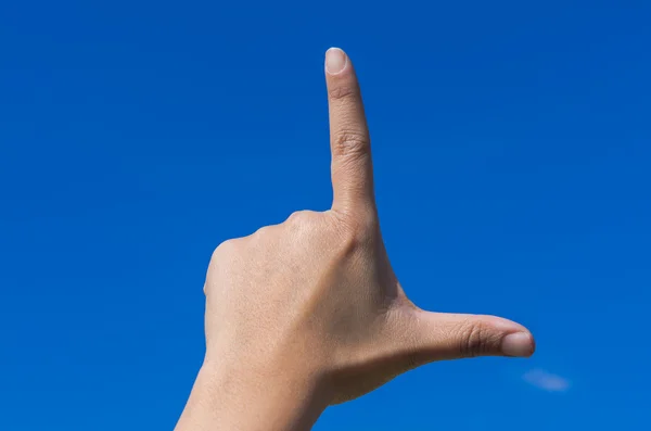 Hands forming L character for love with blue sky — Stock Photo, Image