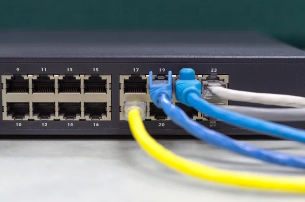Parte del conmutador de red con cable LAN en la mesa de la oficina, frontal — Foto de Stock