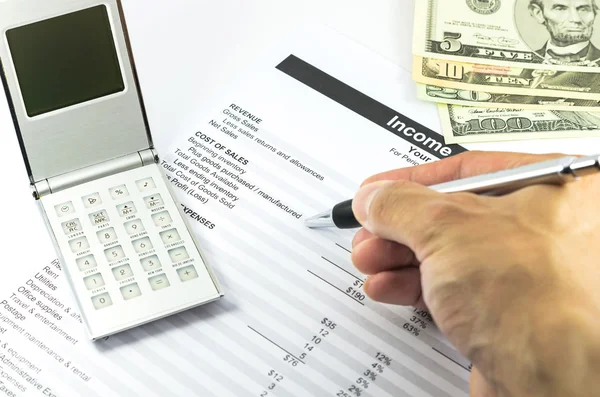 Mark on income statement report with calculator, pen and usd mon — Stock Photo, Image