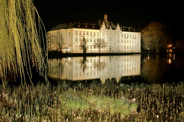 School building in the mirror of pond by night in Litovel, Czech Republic — Stock Photo, Image