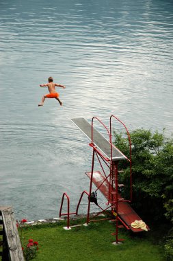 Boy jumps into the lake clipart