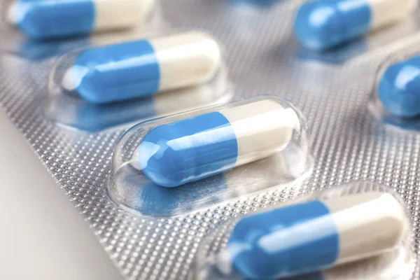 Blue and white pills — Stock Photo, Image