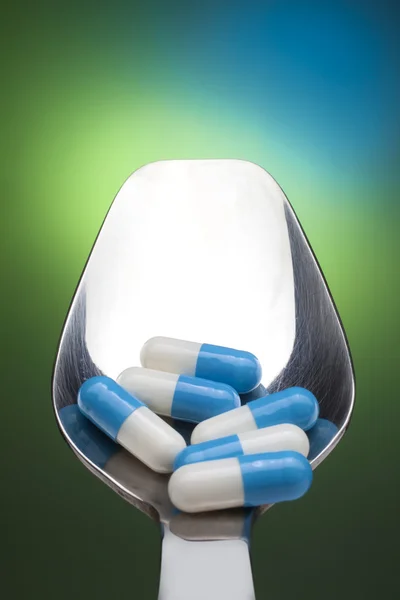 Spoon full of pills — Stock Photo, Image