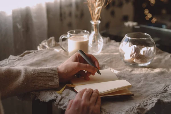 Table with a cup of tea or coffe in beige colors. Winter morning.