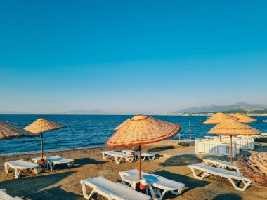 Bamboo beach umbrella on blue sky background. Summer concept.