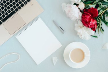 Modern woman home office concept. Computer, coffee and flowers.