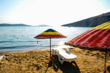 Colorful straw beach umbrellas at the seaside. Summer vocations concept.