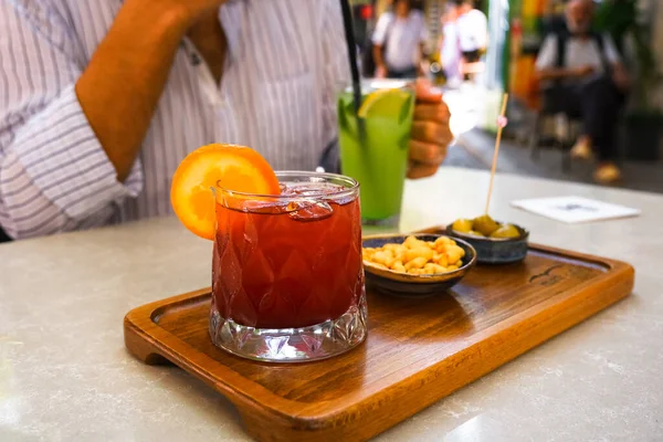 Fresh cold sangria cocktail on the table of the terrace of summer cafe. Lifestyle photo.