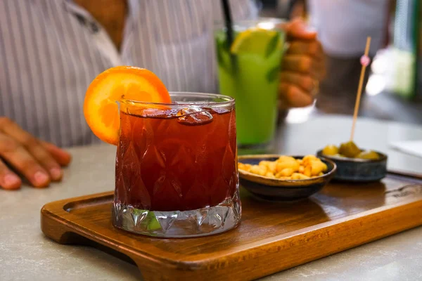 Fresh cold sangria cocktail on the table of the terrace of summer cafe. Lifestyle photo.