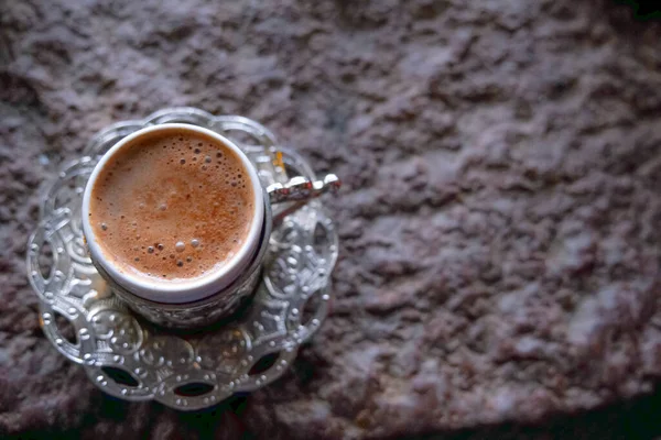 Copper cups with Turkish coffee cooked in hot sand. Travel Turkey.