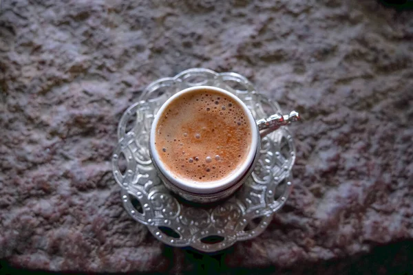 Copper cups with Turkish coffee cooked in hot sand. Travel Turkey.