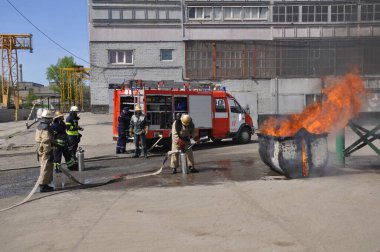 Ukraine, Krivoy Rog September 2, 2021. Firefighters deploy fire hose to extinguish a fire