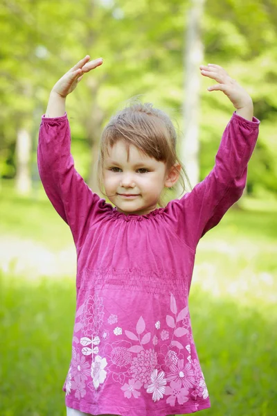 Liten flicka på det gröna gräset — Stockfoto