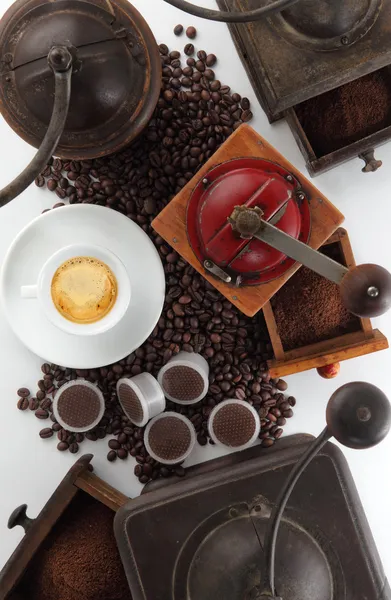 Composition of grinders for coffee with cup, beans and capsules — Stock Photo, Image