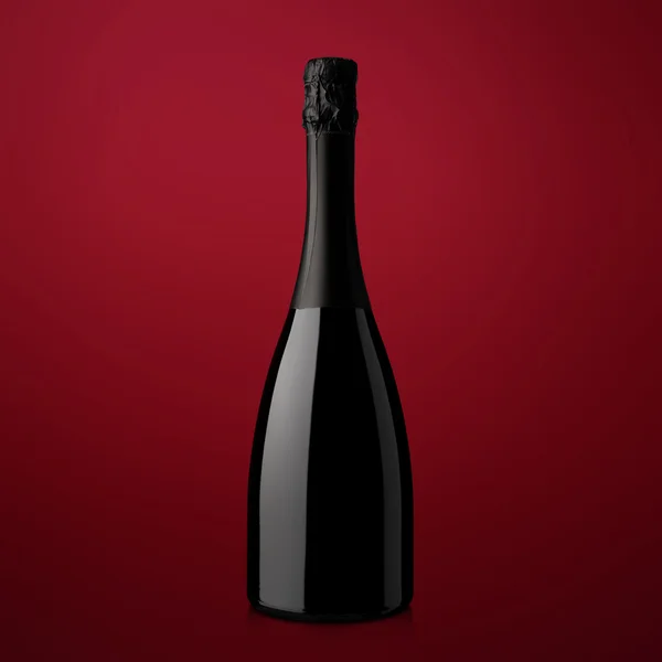 Bottle of sparkling wine on a red background — Stock Photo, Image