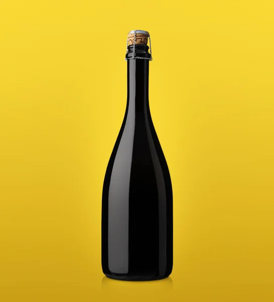 Bottle of sparkling wine with cork on a colored background — Stock Photo, Image