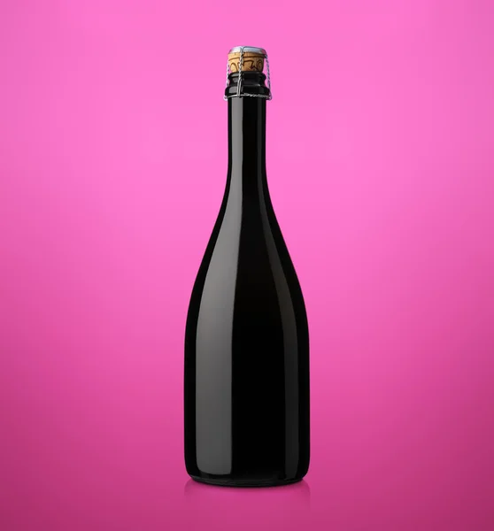 Bottle of sparkling wine with cork on a colored background — Stock Photo, Image