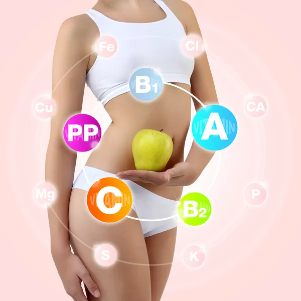 Woman holding an apple with his hands near the belly — Stock Photo, Image