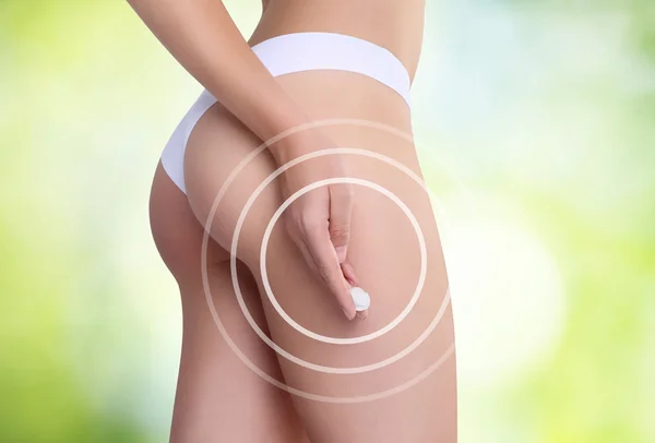 Woman applying cosmetic cream from cellulite on the buttocks — Stock Photo, Image