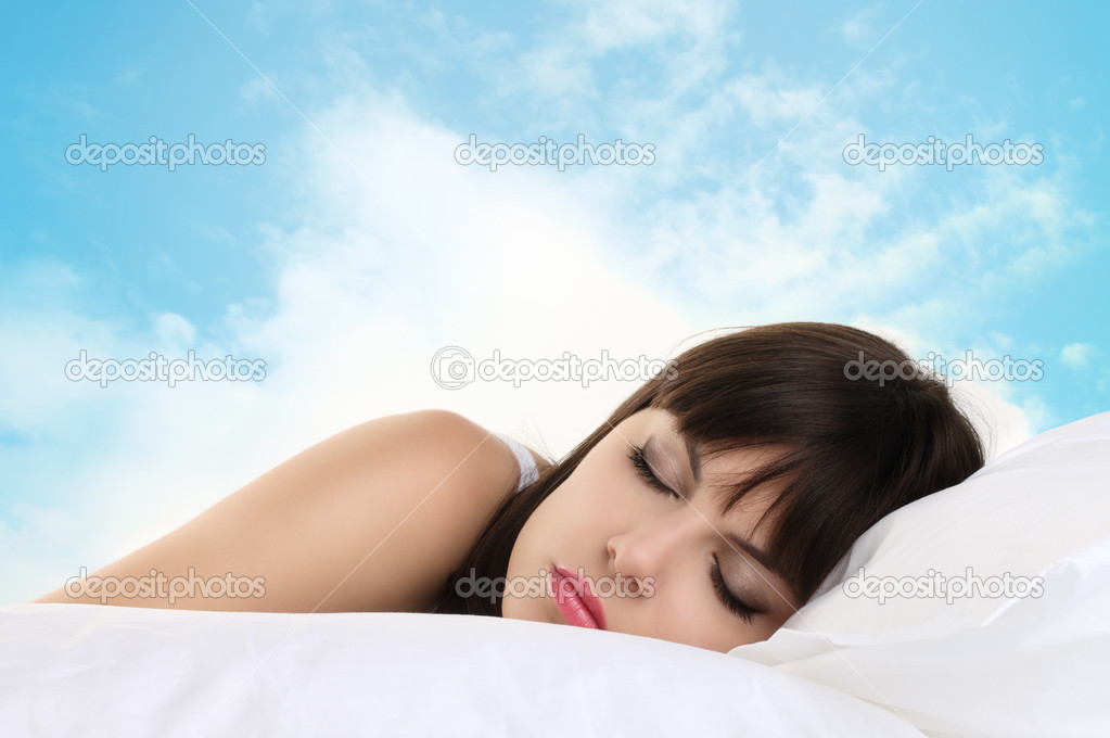Head woman sleeping on pillow with blue sky in background