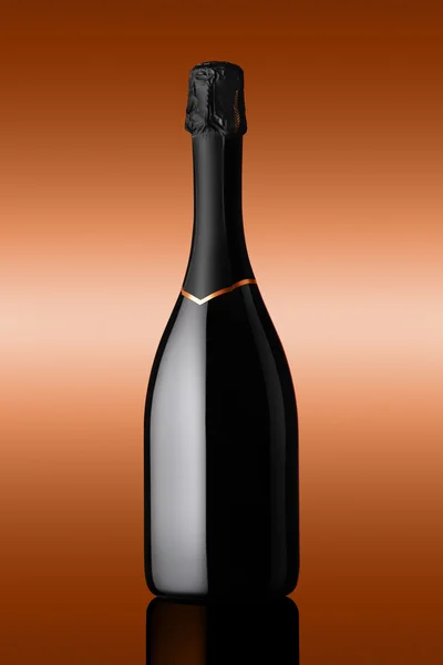 Bottle of sparkling wine on background bronzed — Stock Photo, Image
