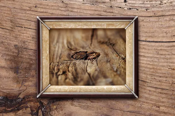 Old frame on a wooden background — Stock Photo, Image