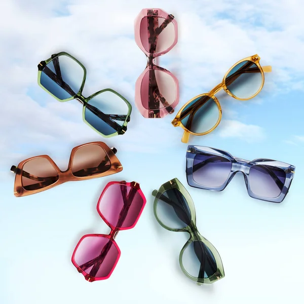 Sunglasses composition in many bright colors in transparent plastic. Top view with shadow. Trendy glasses isolated on sky background. Glasses with polarized lenses. Fashionable eyewear for women.