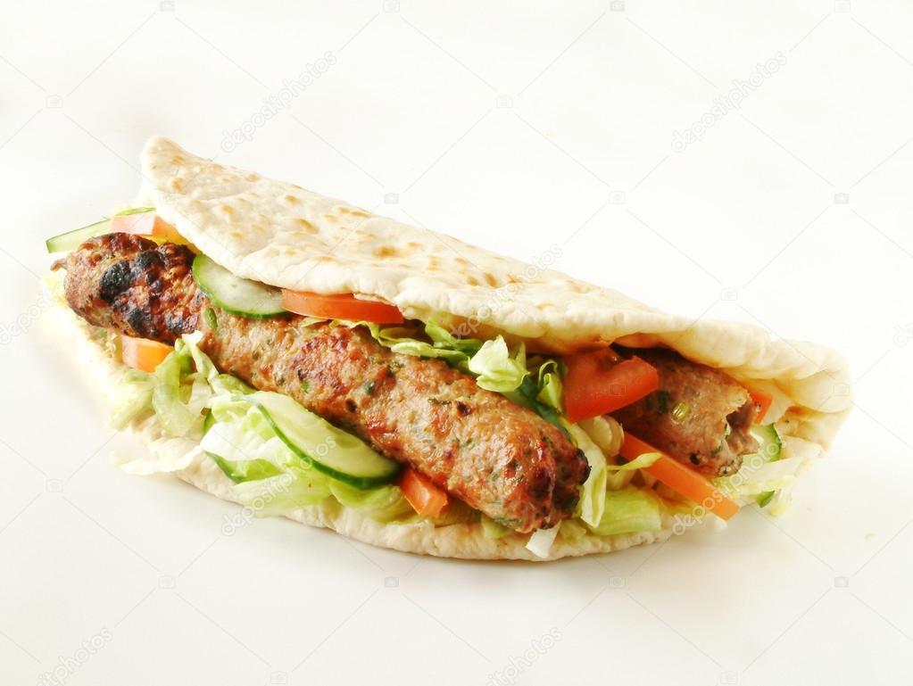 Indian shish kofta kebab wrapped in naan bread — Stock Photo