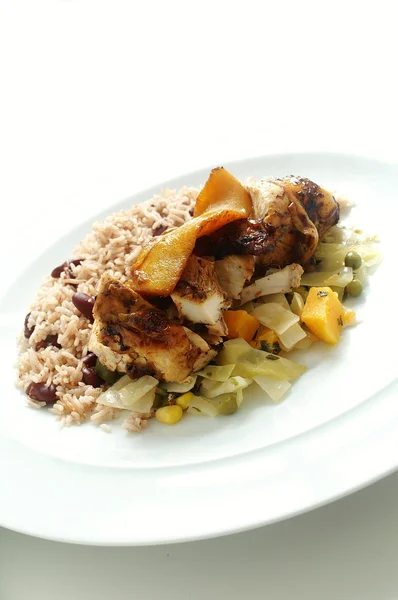 Jamaican style jerk chicken with rice peas and braised cabbage — Stock Photo, Image