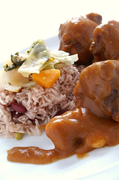 Caribbean style curried Oxtail served with rice mixed with red kidney beans — Stock Photo, Image