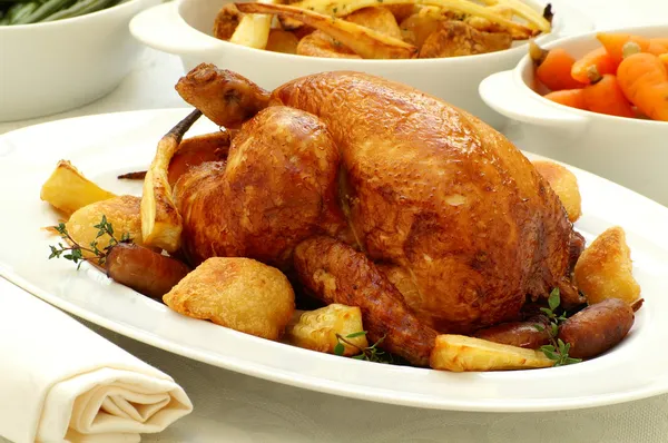 Traditional roast chicken with vegetables Stock Image