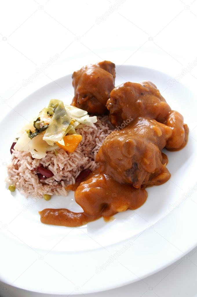 Caribbean style curried Oxtail served with rice mixed with red kidney beans