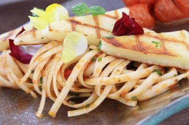 Spaghetti with grilled  halloumi clipart
