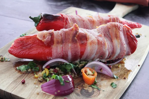 Stuffed peppers wrapped in ham — Stock Photo, Image