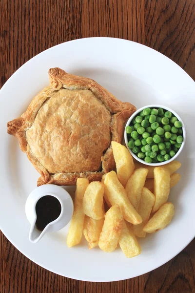 Steak pie with fries and peas plated meal — Stock Photo, Image