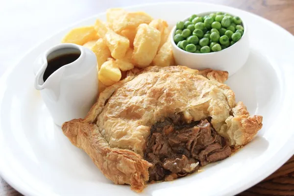Steak pie with fries and peas plated meal — Stock Photo, Image