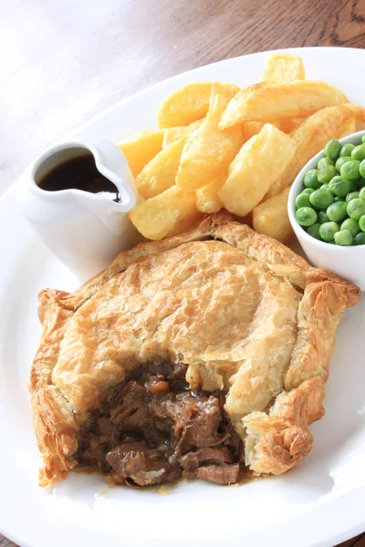 Steak pie with fries and peas plated meal — Stock Photo, Image