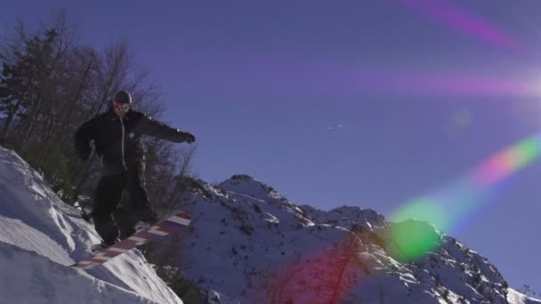 Snowboarder jumping a kicker — Stock Video