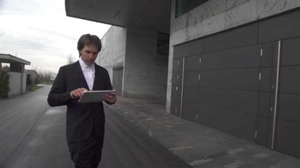 Бизнесмен, работающий над цифровым планшетом — стоковое видео