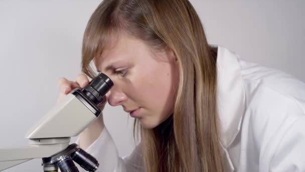 Doctor with tablet and microscope — Stock Video