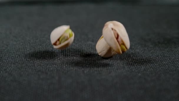 MACRO, DOF: Raw pistachio nuts get scattered across the cloth-covered table. — Vídeo de Stock