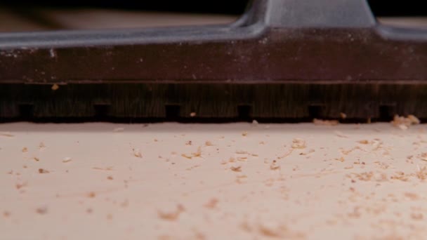 MACRO: Dust brush attachment of a vacuum cleaner sucks up particles of wood. — Stock Video