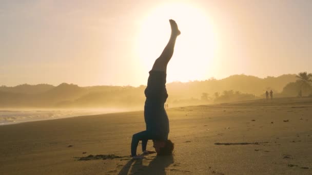 Still Shot Vital Young Man Practising Yoga Headstand Exotic Beach — Vídeos de Stock