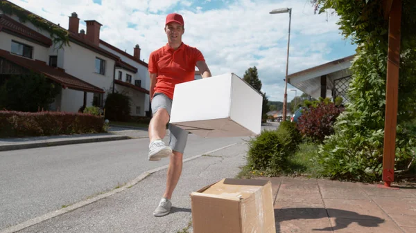 Low Angle Reckless Caucasian Parcel Delivery Guy Drop Kicks Package — Stock Photo, Image