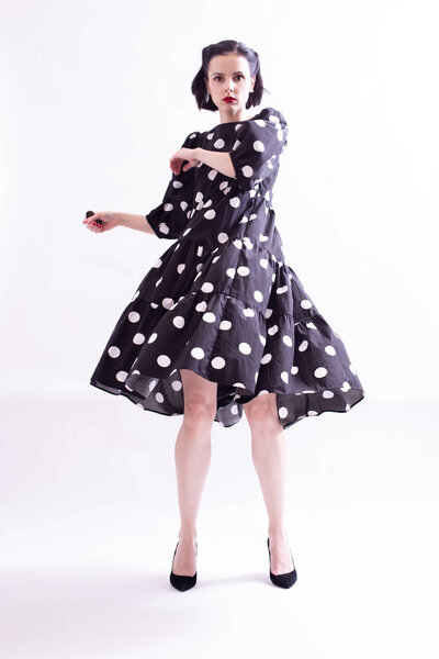 beautiful woman in a dress with polka dots with a red mouth