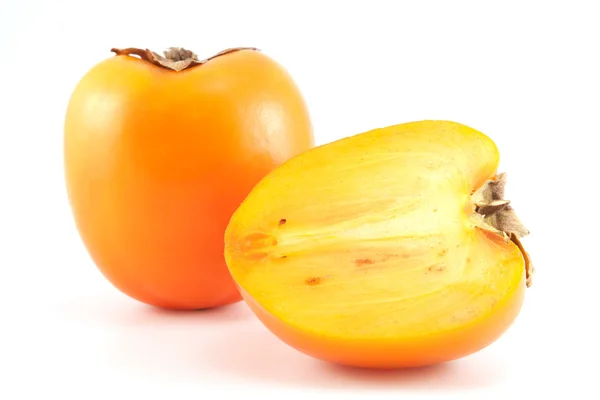 Cáqui-de-laranja com um fatiado — Fotografia de Stock