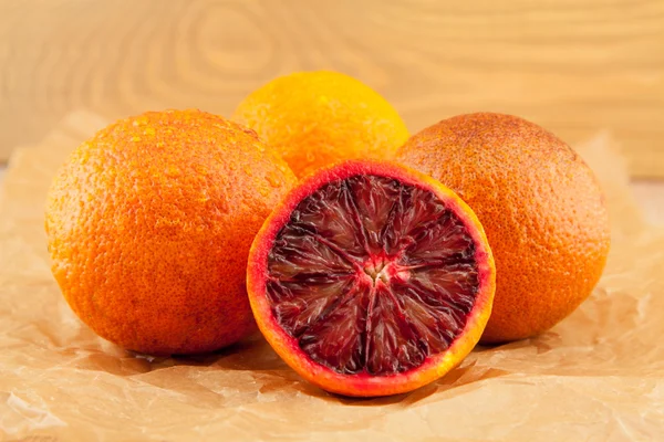 Ripe red blood oranges and slices — Stock Photo, Image
