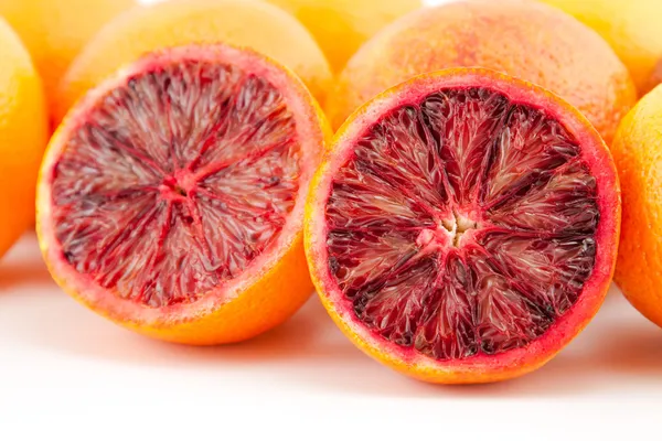 Ripe red blood oranges and slices — Stock Photo, Image