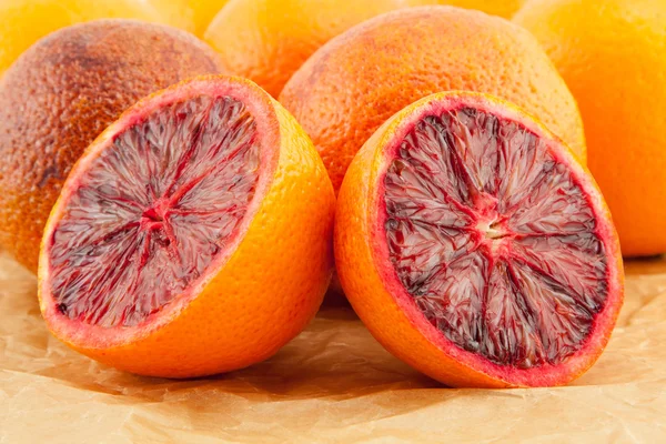 Ripe red blood oranges and slices — Stock Photo, Image